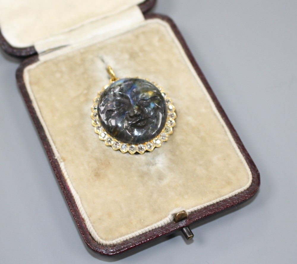 A 20th century yellow metal, diamond and carved labradorite? moon face pendant, 26mm, gross weight 7.2 grams.